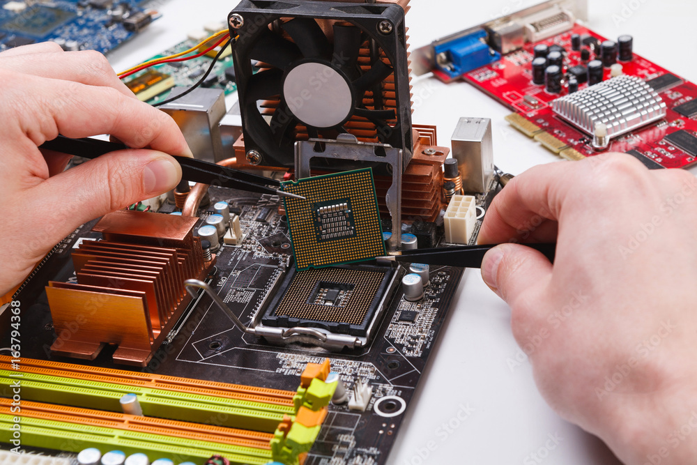 Poster technician plug in microprocessor to motherboard