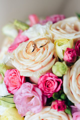 gold wedding rings on bride's bouquet