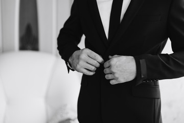 Obraz premium A man in a jacket on a light background, a groom's fees, black and white