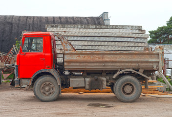 Obraz premium Empty old soviet tipper truck on construction site.