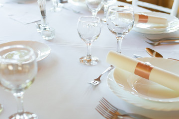 table setting with spoon, knife, plates and glass