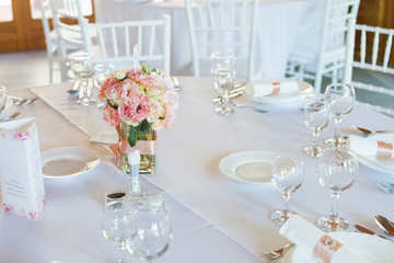 table setting with spoon, knife, plates and glass