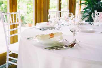 table setting with spoon, knife, plates and glass