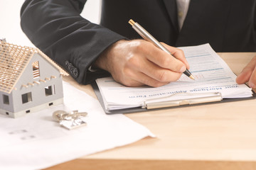  Businessman signing a mortgage  contract  of a sale for a new house