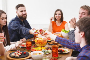 Group of happy people at festive table dinner party