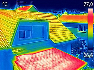 Infrared thermovision image showing Warmed roofs on family homes - 163800529