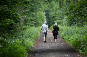 Fototapeta na wymiar Man and woman walking in forest