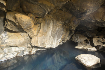 Cave and calm water with reflections