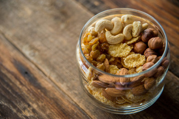 Homemade granola with nuts and seeds in glass jar for healthy breakfast