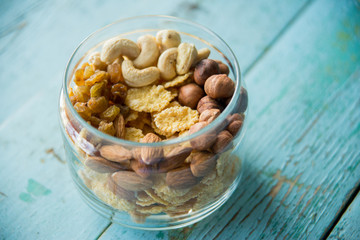 Homemade granola with nuts and seeds in glass jar for healthy breakfast