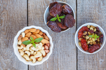 Different types of nuts and dried fruits.  Healthy dietary snack, dried fruit, nuts, top view.
