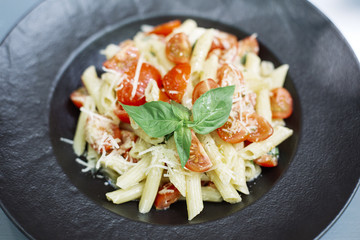 Penne pasta with cheese and cherry tomato
