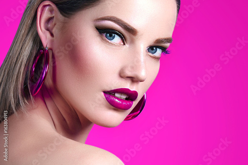 A Beautiful Sweet Well Groomed Girl On A Bright Pink Background