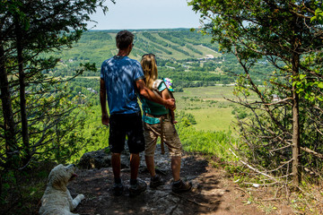 Young family hiking with their dog and their newborn