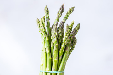 Fresh green asparagus on white