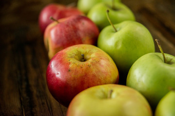 Fresh red apples with green leaves on wooden table. On wooden background. Free space for text . Top view
