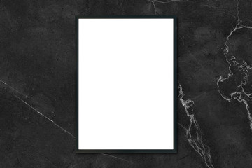 Mock up blank poster picture frame hanging on black marble wall in room - can be used mockup for montage products display and design key visual layout.