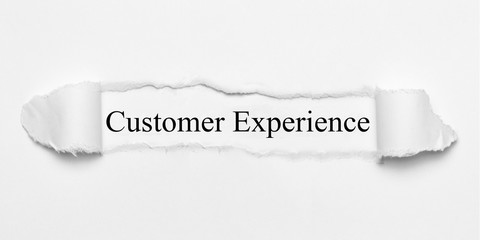 Customer Experience on white torn paper