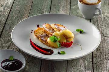 Plate of toasts with fruit jam and custard for healthy breakfast. Delicious European meal.