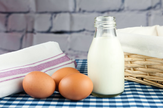 eggs and milk on a blue gingham table cloth