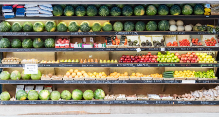 Rows of fresh fruits and vegetables at a corner market in New York City