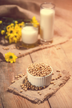 Soy milk or soya milk and soy beans on wooden table.