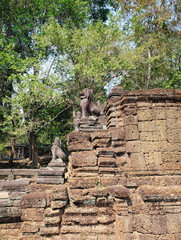 Lions in the foreground guarding Preah Khan Temple in Angkor Complex, Siem Reap, Cambodia. Ancient Khmer architecture and famous Cambodian landmark, World Heritage.