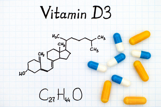 Chemical formula of Vitamin D3 and pills
