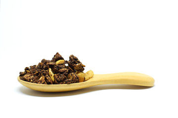 Chocolate Granola in the wooden spoon on white background.