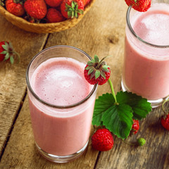Delicious fruit milkshake made of fresh ripe strawberry and milk. Diet drink for healthy breakfast. Top view.