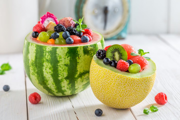 Fruits salad in watermelon and melon with berry fruits