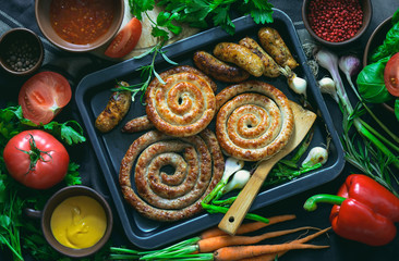 Roasted spicy sausages garnished with greens