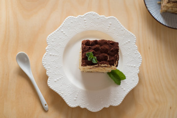 Tiramisu cake on a white porcelain plate