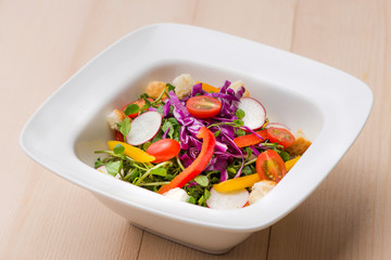 Homemade fresh green vegetable salad on table.