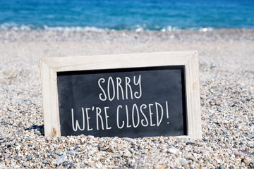 text sorry we are closed in a chalkboard