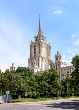 A beautiful tall building, a Stalin skyscraper on the background of a part of the building of the ukraine hotel against the blue sky