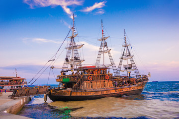 Fototapeta na wymiar Beautiful old pirates boat, illuminated by sunset light, in Thessaloniki seaport, Greece