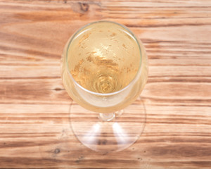 Glass of white wine on vintage wooden background