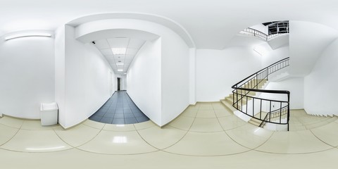 Big white hallway with staircase stairs white recycling bin trash can with blue and white floor...