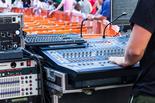 Man using a mixing console in live concert