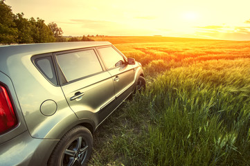 Obraz premium Car travelling. Vehicle on a nature field as concept eco technology.