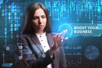 The concept of business, technology, the Internet and the network. A young entrepreneur working on a virtual screen of the future and sees the inscription: Boost your business