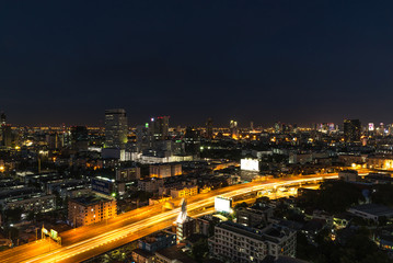 Fototapeta na wymiar Cityscape and light of night road in long exposure