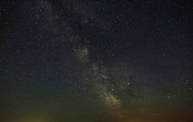 Naklejka na ściany i meble Starry night sky with the Milky Way. Astrophotography of the open space.