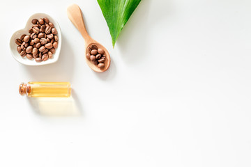 Coffee grains and oil on wooden table background top view copyspace