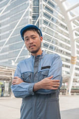 Business engineer standing and post in front of building.