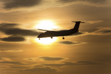 passenger airplane in front of a sundown
