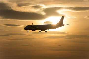 passenger airplane in front of a sundown