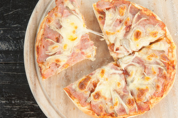 Homemade ham cheese lay on wooden tray.