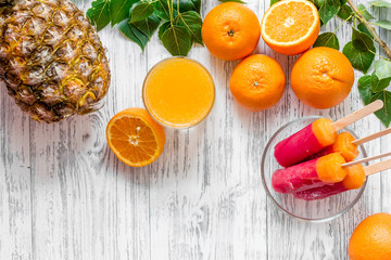 Obraz na płótnie Canvas Orange juice, oranges, mandarins and citrus ice cream on wooden table background top view copyspace